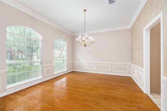 3102 Stargate Ct, Houston, TX 77068 - unfurnished room with ornamental molding, a chandelier, light wood-type flooring, a wainscoted wall, and a decorative wall