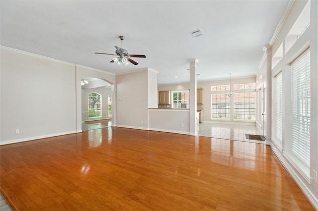 3102 Stargate Ct, Houston, TX 77068 - unfurnished living room featuring a ceiling fan, light wood finished floors, plenty of natural light, and crown molding