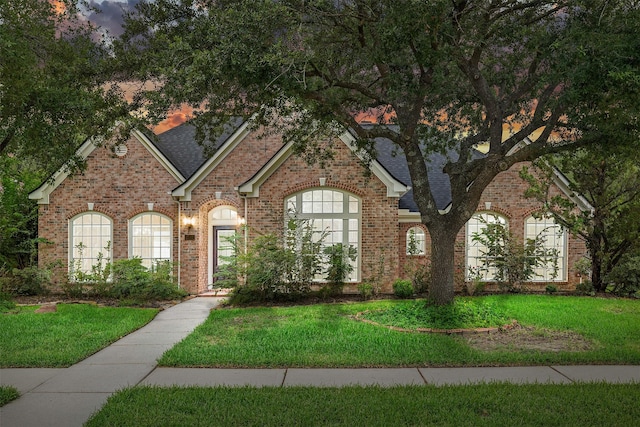 3102 Stargate Ct, Houston, TX 77068 - view of front facade featuring brick siding, a front lawn, and a shingled roof