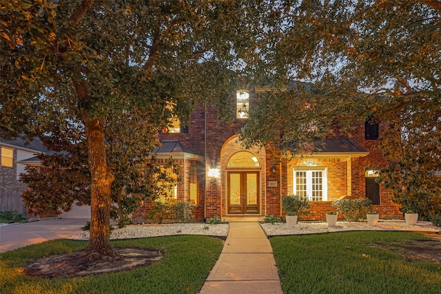 8707 Crossriver Ln, Houston, TX 77095 - obstructed view of property featuring french doors, brick siding, a front lawn, and driveway