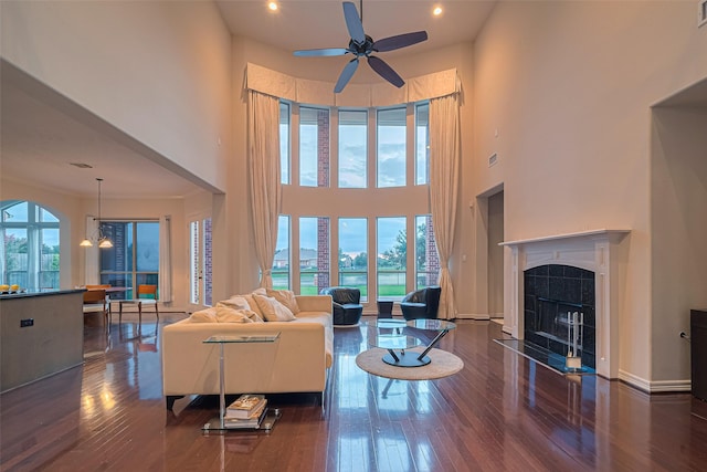 8707 Crossriver Ln, Houston, TX 77095 - living area with plenty of natural light, a ceiling fan, hardwood / wood-style flooring, a tile fireplace, and a high ceiling