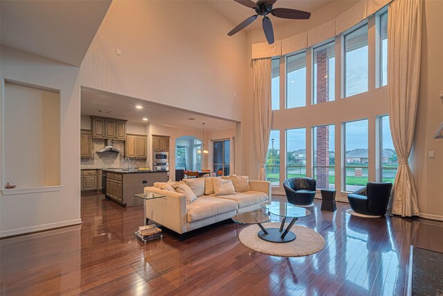 8707 Crossriver Ln, Houston, TX 77095 - living area featuring a high ceiling, ceiling fan, and dark wood-type flooring