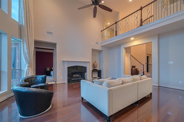 8707 Crossriver Ln, Houston, TX 77095 - living area with a high ceiling, wood finished floors, stairway, ceiling fan, and a premium fireplace