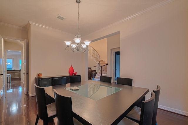 8707 Crossriver Ln, Houston, TX 77095 - dining room with stairs, a chandelier, dark wood-style floors, and ornamental molding
