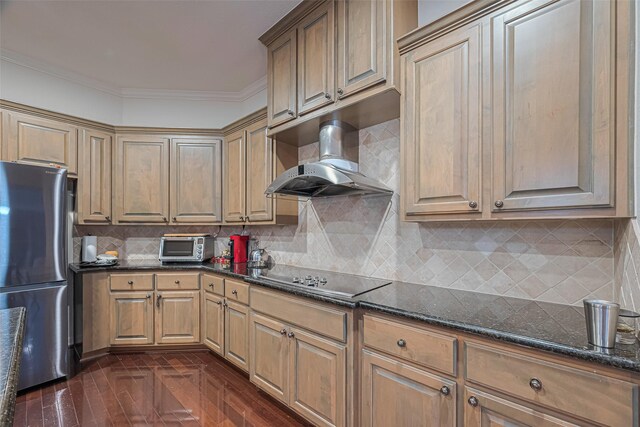 8707 Crossriver Ln, Houston, TX 77095 - kitchen featuring freestanding refrigerator, black electric cooktop, wall chimney exhaust hood, dark stone countertops, and ornamental molding