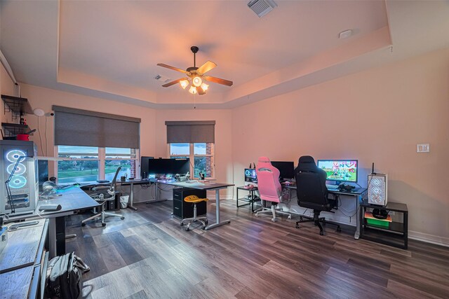 8707 Crossriver Ln, Houston, TX 77095 - home office featuring a tray ceiling, a ceiling fan, and dark wood finished floors