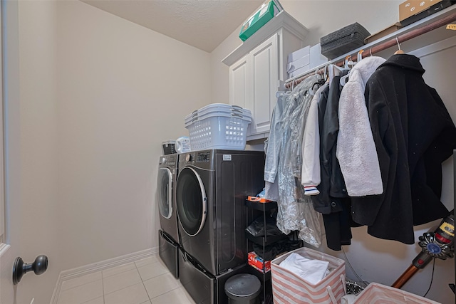 8707 Crossriver Ln, Houston, TX 77095 - laundry area with independent washer and dryer, tile patterned floors, and cabinet space
