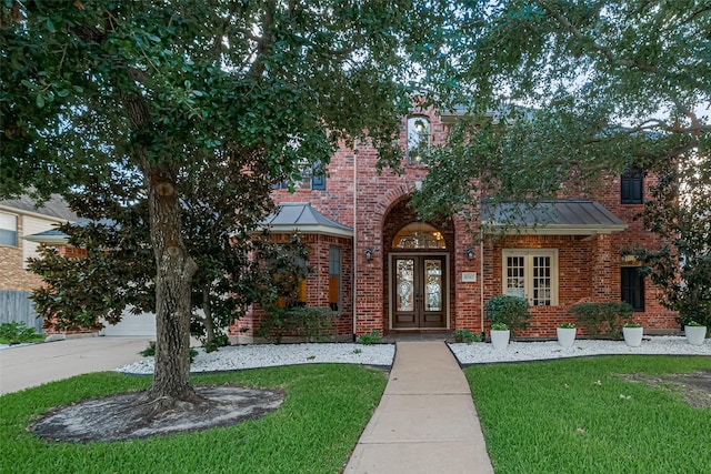 8707 Crossriver Ln, Houston, TX 77095 - view of front of home with french doors, brick siding, and a front lawn