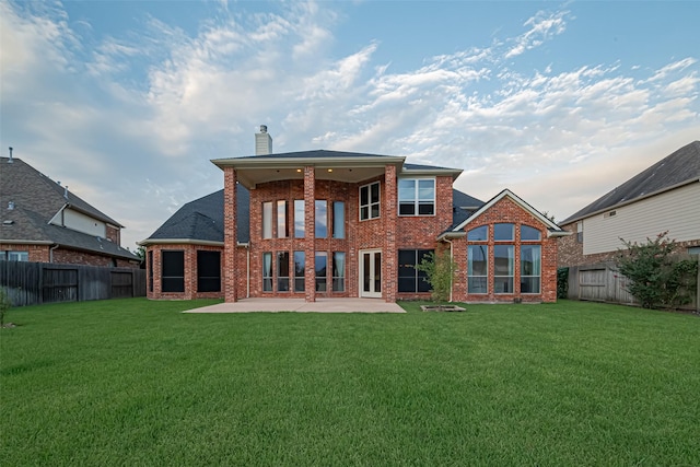 8707 Crossriver Ln, Houston, TX 77095 - back of property featuring brick siding, a chimney, a fenced backyard, and a patio