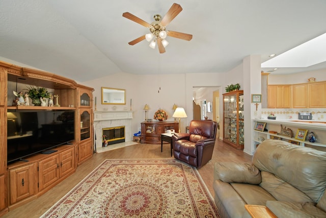 1512 Pine Ridge Ln, Pearland, TX 77581 - living room featuring a ceiling fan, light wood-type flooring, lofted ceiling, and a high end fireplace