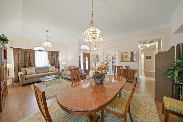 1512 Pine Ridge Ln, Pearland, TX 77581 - dining space featuring a chandelier, light wood finished floors, and ornamental molding