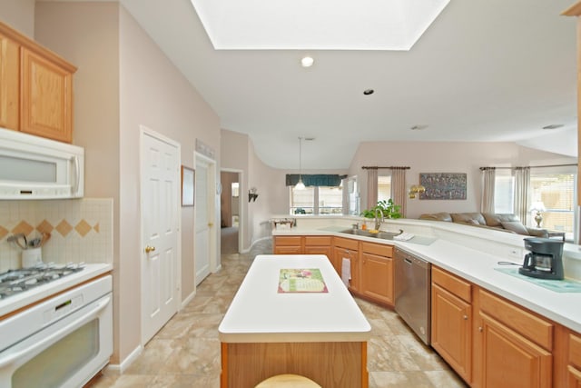 1512 Pine Ridge Ln, Pearland, TX 77581 - kitchen with white appliances, a kitchen island, light countertops, and healthy amount of natural light
