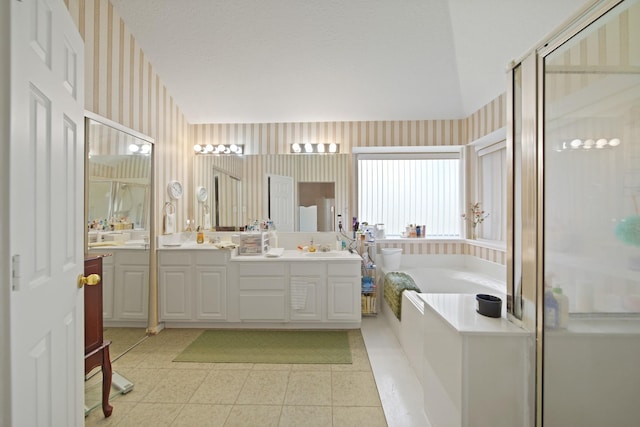 1512 Pine Ridge Ln, Pearland, TX 77581 - bathroom with wallpapered walls, a garden tub, double vanity, a shower stall, and tile patterned floors