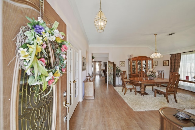 1512 Pine Ridge Ln, Pearland, TX 77581 - entryway with a chandelier, light wood-type flooring, and ornamental molding
