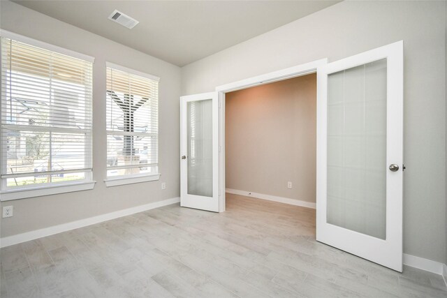 11110 Crocus Dr, Houston, TX 77044 - unfurnished bedroom with french doors and light wood-style floors