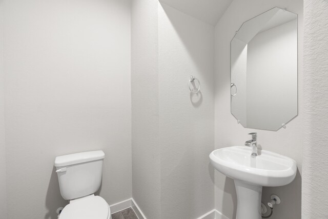 11110 Crocus Dr, Houston, TX 77044 - half bathroom featuring toilet and baseboards