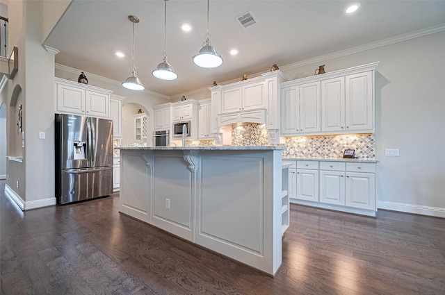 19415 Maifest Dr, Cypress, TX 77433 - kitchen with appliances with stainless steel finishes, arched walkways, dark wood-type flooring, backsplash, and white cabinetry