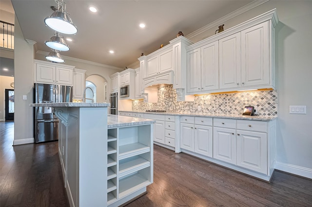 19415 Maifest Dr, Cypress, TX 77433 - kitchen featuring stainless steel appliances, arched walkways, dark wood finished floors, white cabinetry, and crown molding