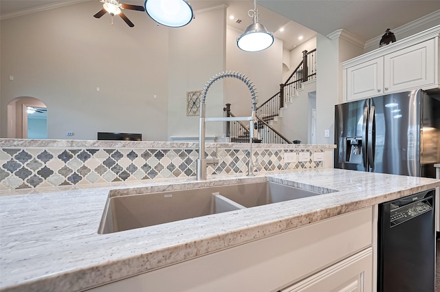 19415 Maifest Dr, Cypress, TX 77433 - kitchen featuring dishwasher, a ceiling fan, crown molding, arched walkways, and white cabinets