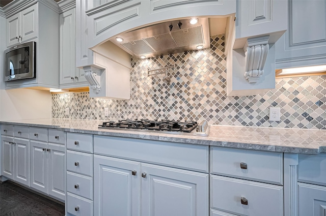 19415 Maifest Dr, Cypress, TX 77433 - kitchen with appliances with stainless steel finishes, tasteful backsplash, and light stone counters