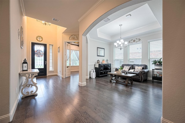 19415 Maifest Dr, Cypress, TX 77433 - foyer with arched walkways, crown molding, dark wood-style floors, a tray ceiling, and a chandelier