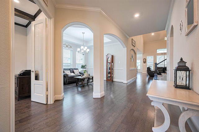 19415 Maifest Dr, Cypress, TX 77433 - foyer entrance with plenty of natural light, crown molding, dark wood-style floors, arched walkways, and a chandelier
