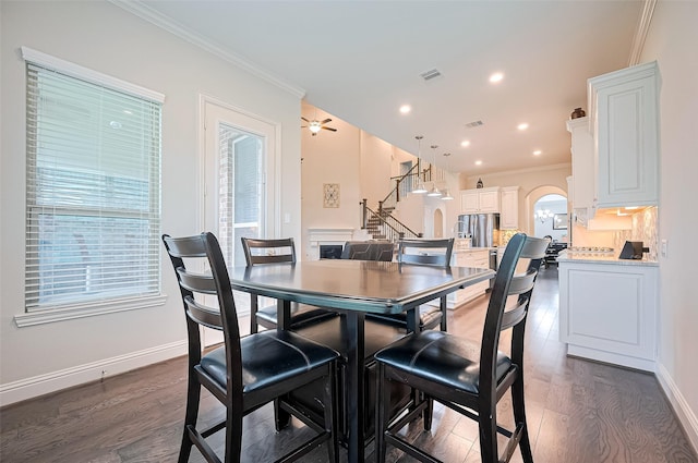 19415 Maifest Dr, Cypress, TX 77433 - dining area with ornamental molding, dark wood-style flooring, arched walkways, and recessed lighting