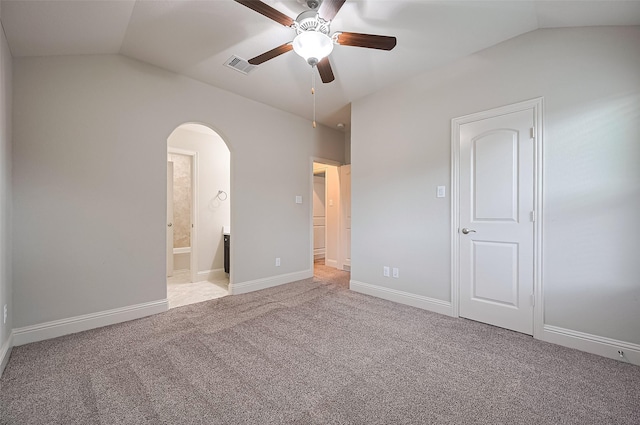 19415 Maifest Dr, Cypress, TX 77433 - unfurnished bedroom featuring vaulted ceiling, arched walkways, carpet flooring, connected bathroom, and a ceiling fan