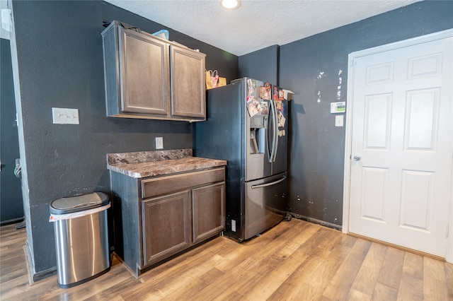 1119 Grassy View Dr, Houston, TX 77073 - kitchen featuring stainless steel fridge with ice dispenser, light wood-type flooring, and a textured ceiling