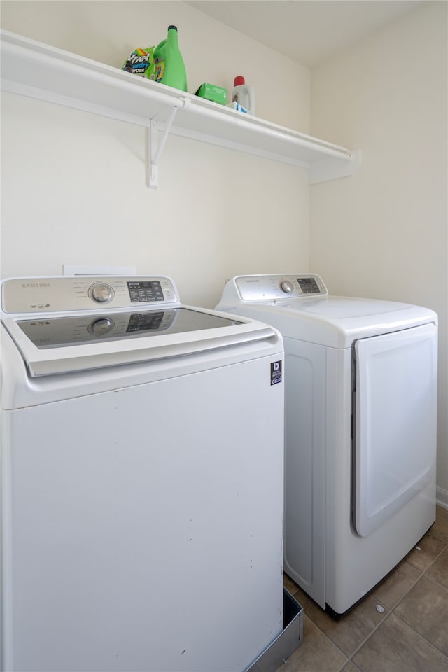 1119 Grassy View Dr, Houston, TX 77073 - laundry room with independent washer and dryer and tile patterned flooring