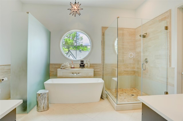5007 Dickson St, Houston, TX 77007 - full bath with a soaking tub, tile walls, a shower stall, vanity, and tile patterned floors