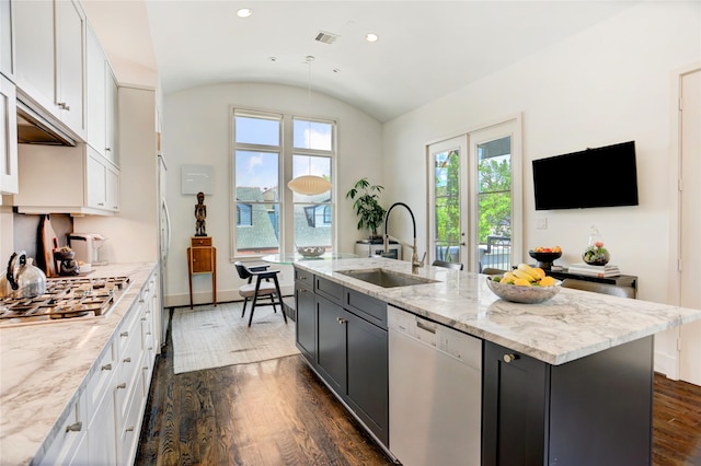 5007 Dickson St, Houston, TX 77007 - kitchen with white dishwasher, stainless steel gas stovetop, white cabinetry, dark wood-style flooring, and vaulted ceiling