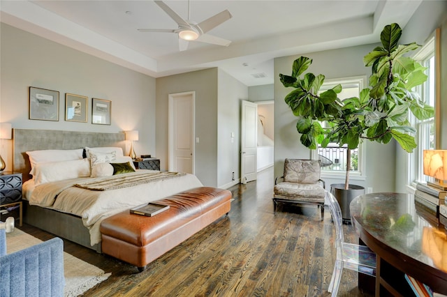 5007 Dickson St, Houston, TX 77007 - bedroom featuring wood finished floors, a raised ceiling, and a ceiling fan