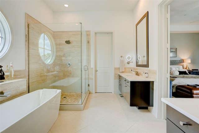 5007 Dickson St, Houston, TX 77007 - ensuite bathroom featuring a stall shower, vanity, a freestanding bath, and tile patterned flooring