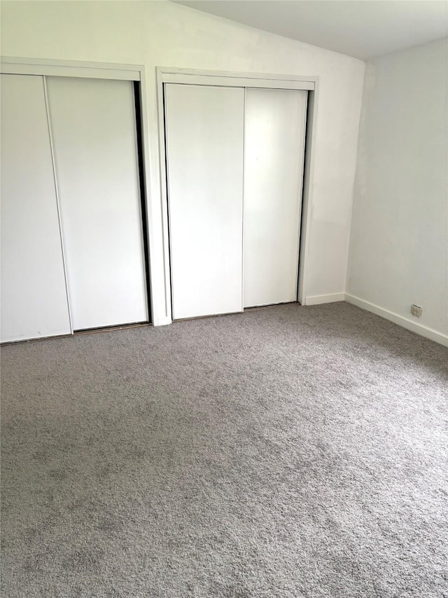 103 Greenbriar Dr, Wharton, TX 77488 - unfurnished bedroom featuring two closets and carpet flooring