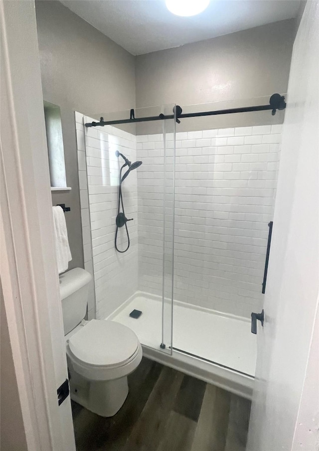 103 Greenbriar Dr, Wharton, TX 77488 - bathroom featuring a stall shower and wood finished floors