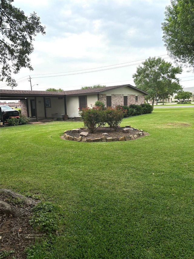 103 Greenbriar Dr, Wharton, TX 77488 - view of grassy yard featuring a carport