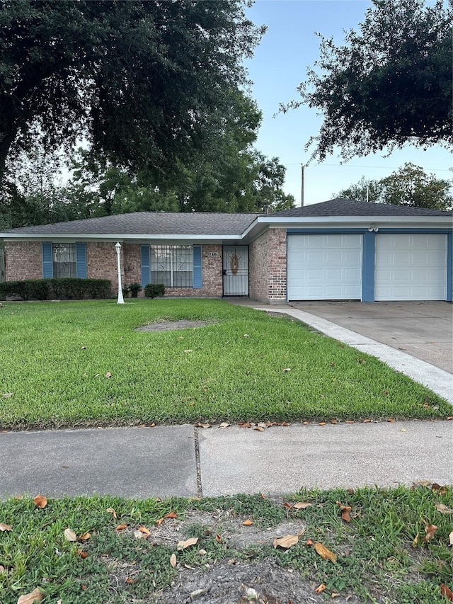 1307 Rim Rock Dr, Houston, TX 77088 - single story home with an attached garage, a front lawn, driveway, and brick siding