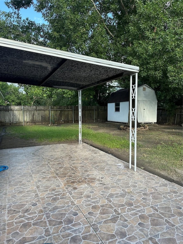 1307 Rim Rock Dr, Houston, TX 77088 - fenced backyard with a storage unit, a patio area, and a carport