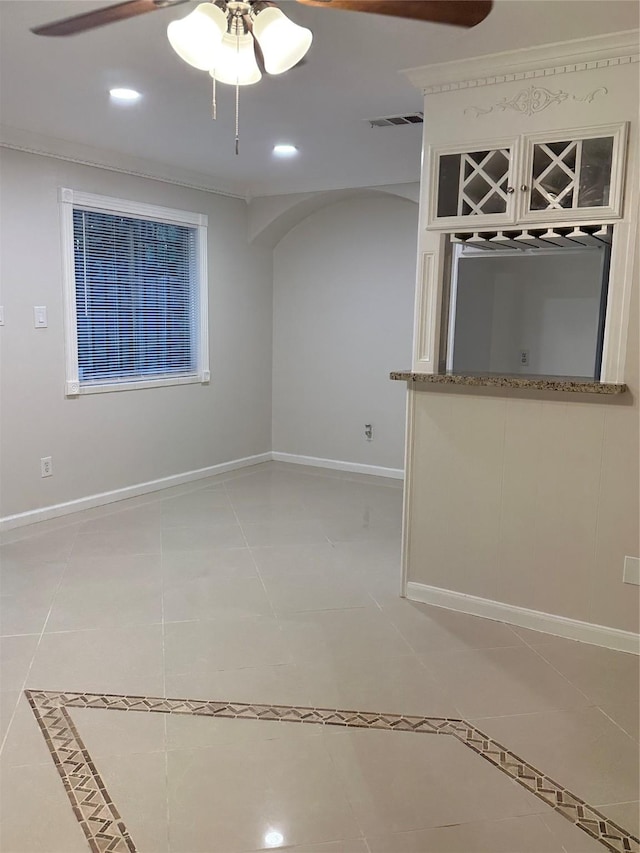 1307 Rim Rock Dr, Houston, TX 77088 - spare room featuring arched walkways, ceiling fan, light tile patterned floors, and recessed lighting