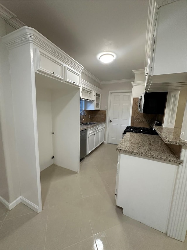 1307 Rim Rock Dr, Houston, TX 77088 - kitchen with appliances with stainless steel finishes, white cabinets, tasteful backsplash, ornamental molding, and light tile patterned flooring