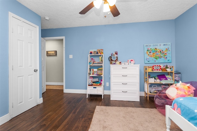 3926 Lavender St, Houston, TX 77026 - bedroom with dark wood-style floors, a textured ceiling, and ceiling fan