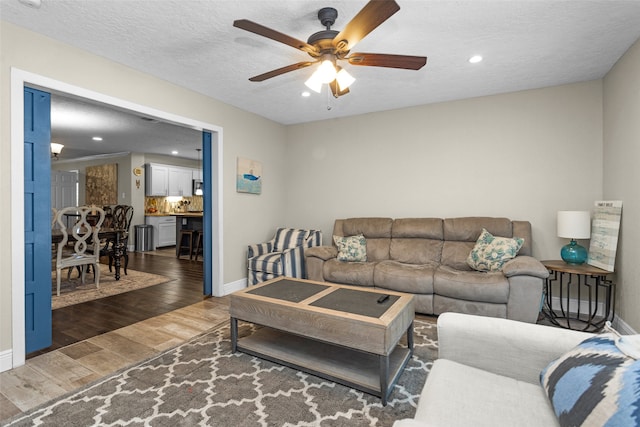3926 Lavender St, Houston, TX 77026 - living room with a ceiling fan, wood finished floors, recessed lighting, and a textured ceiling