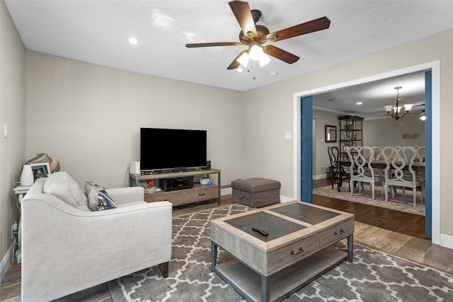 3926 Lavender St, Houston, TX 77026 - living room with wood finished floors, ceiling fan, a chandelier, recessed lighting, and a textured ceiling