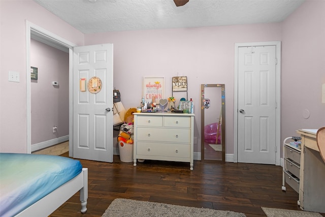 3926 Lavender St, Houston, TX 77026 - bedroom with dark wood-type flooring, a textured ceiling, and a ceiling fan