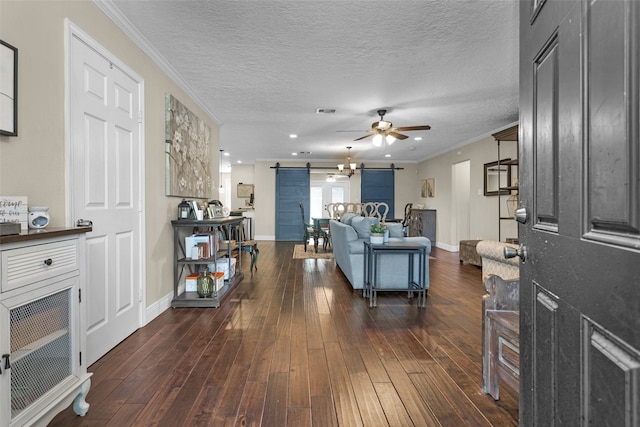 3926 Lavender St, Houston, TX 77026 - living area with a barn door, ceiling fan, dark wood-type flooring, and crown molding