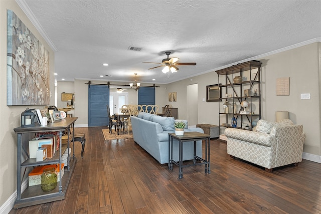 3926 Lavender St, Houston, TX 77026 - living room featuring a barn door, a ceiling fan, dark wood-type flooring, a textured ceiling, and recessed lighting