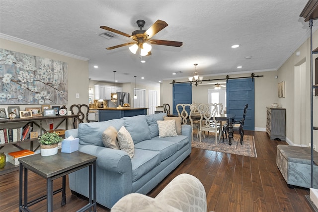 3926 Lavender St, Houston, TX 77026 - living area with a barn door, ceiling fan, dark wood-style floors, ornamental molding, and a textured ceiling