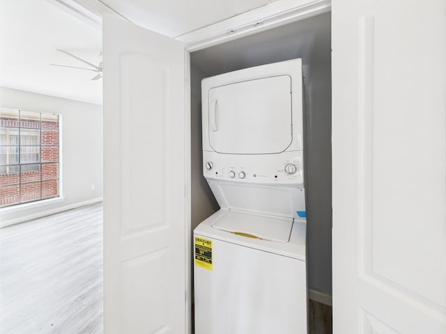 8055 Cambridge St Unit 26, Houston, TX 77054 - washroom with stacked washer / drying machine and wood finished floors
