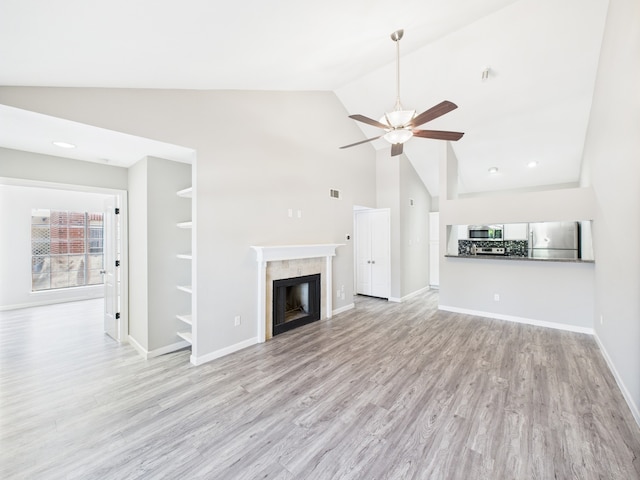 8055 Cambridge St Unit 26, Houston, TX 77054 - unfurnished living room featuring ceiling fan, light wood finished floors, high vaulted ceiling, and a fireplace